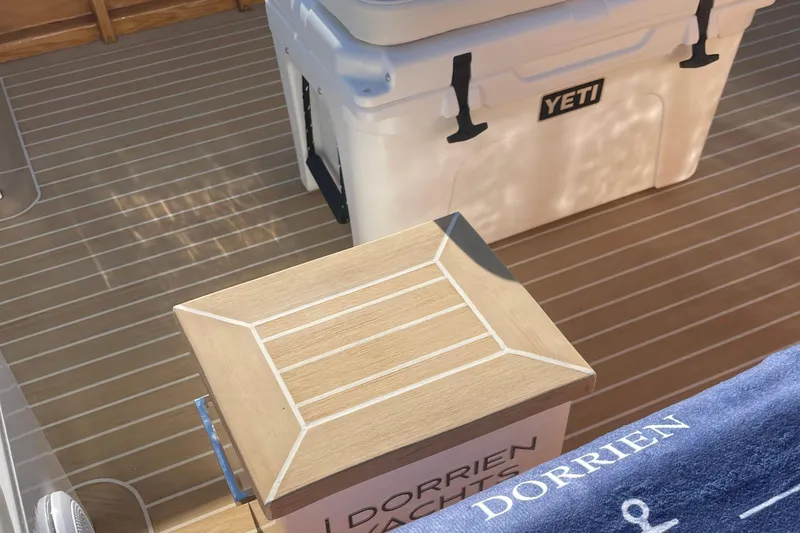 Slide: The Image of Luxury Dorrien Yachts 160T 2025 deck with Yeti cooler and wooden accents. - 15