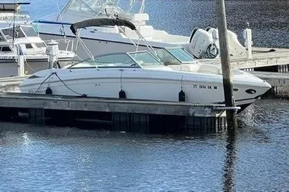 The Image of 2008 Cobalt 252 boat docked in a marina, surrounded by water and other boats. - 0