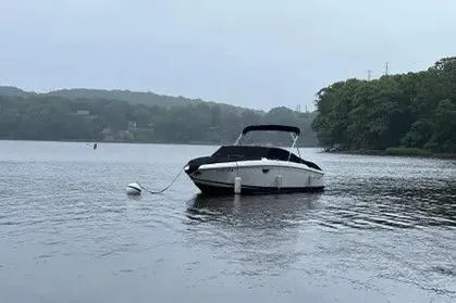 Slide: The Image of 2008 Cobalt 252 boat moored on a calm lake with forested shoreline. - 10