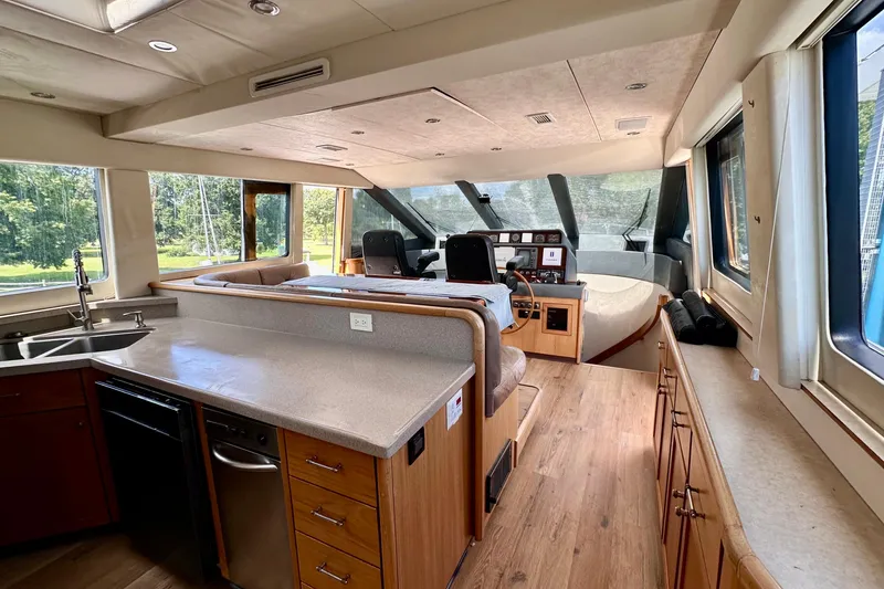 Slide: The Image of Luxurious interior of 2000 Pacific Mariner 65 Motoryacht with elegant seating and table. - 10