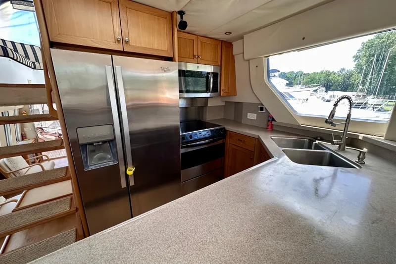 Slide: The Image of Luxurious kitchen interior of 2000 Pacific Mariner 65 Motoryacht with modern appliances. - 12