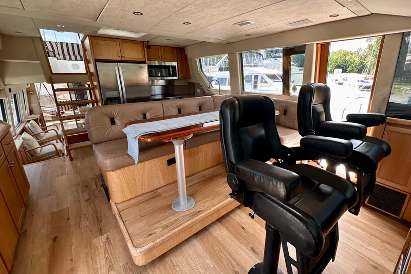 Slide: The Image of Luxurious interior of 2000 Pacific Mariner 65 Motoryacht with modern kitchen and dining area. - 14