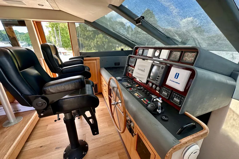 Slide: The Image of Interior view of 2000 Pacific Mariner 65 Motoryacht helm with dual seats and navigation equipment. - 16