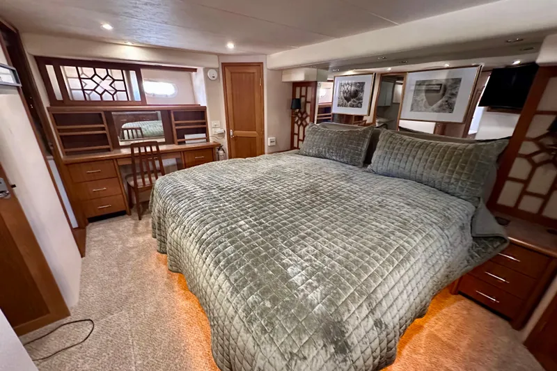 Slide: The Image of Curved staircase inside 2000 Pacific Mariner 65 Motoryacht, featuring carpeted steps and wooden handrail. - 19
