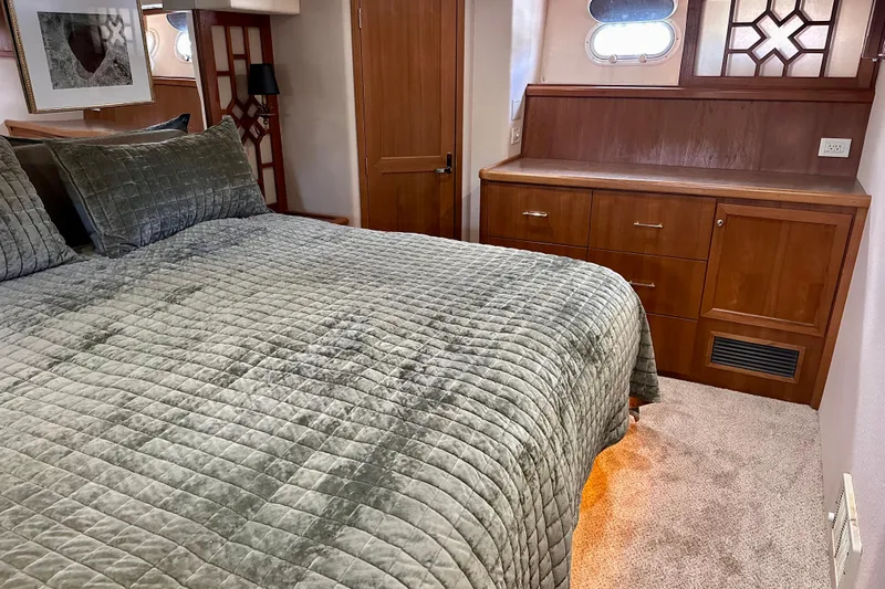Slide: The Image of Luxurious bedroom in 2000 Pacific Mariner 65 Motoryacht with plush bedding and elegant wood furnishings. - 20
