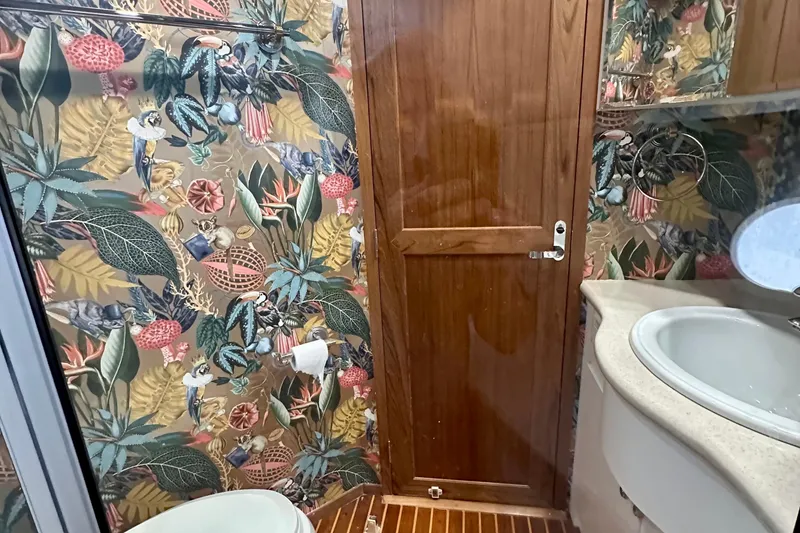 Slide: The Image of Luxurious bathroom in 2000 Pacific Mariner 65 Motoryacht with shower and floral wallpaper. - 27