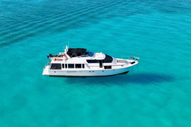 Slide: The Image of 2000 Pacific Mariner 65 Motoryacht docked by a waterfront home. - 3