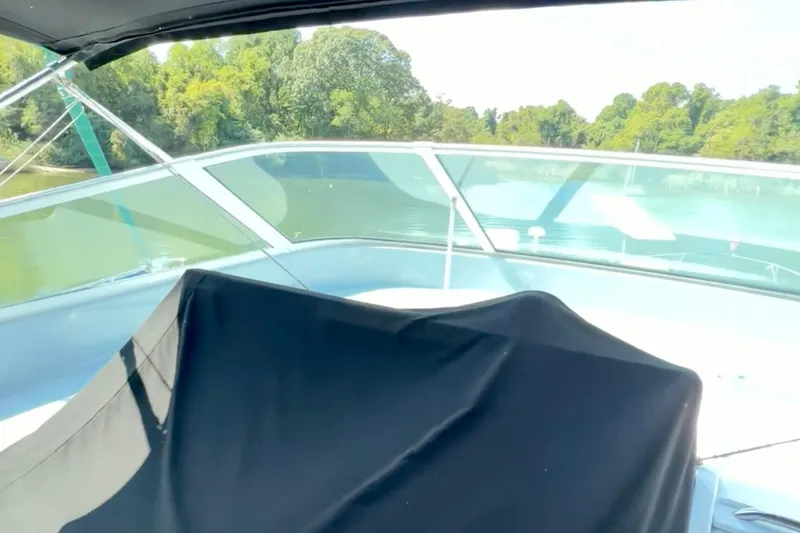 Slide: The Image of 2000 Pacific Mariner 65 Motoryacht docked at a marina with scenic water view. - 35