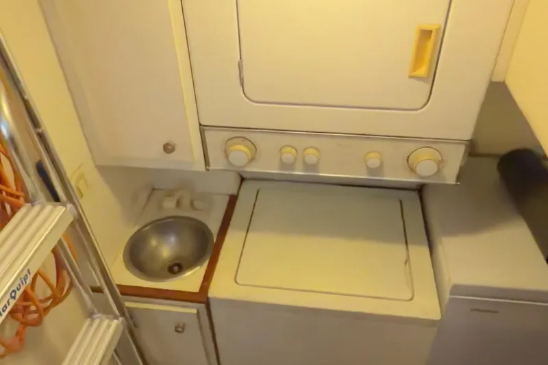 Slide: The Image of Laundry area in 2000 Pacific Mariner 65 Motoryacht with washer, dryer, and sink. - 43