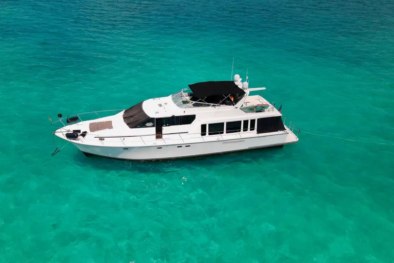 Slide: The Image of 2000 Pacific Mariner 65 Motoryacht cruising on clear turquoise waters. - 51