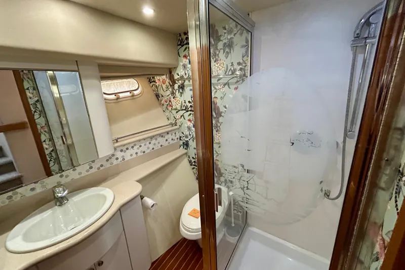 Slide: The Image of Bathroom interior of 2000 Pacific Mariner 65 Motoryacht with floral wallpaper and glass shower. - 52