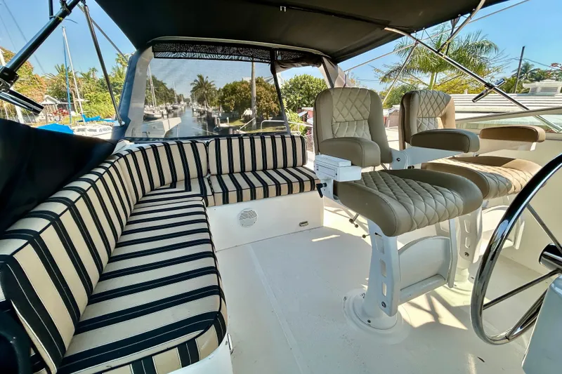 Slide: The Image of Luxurious interior of 2000 Pacific Mariner 65 Motoryacht with striped seating and helm chairs. - 56