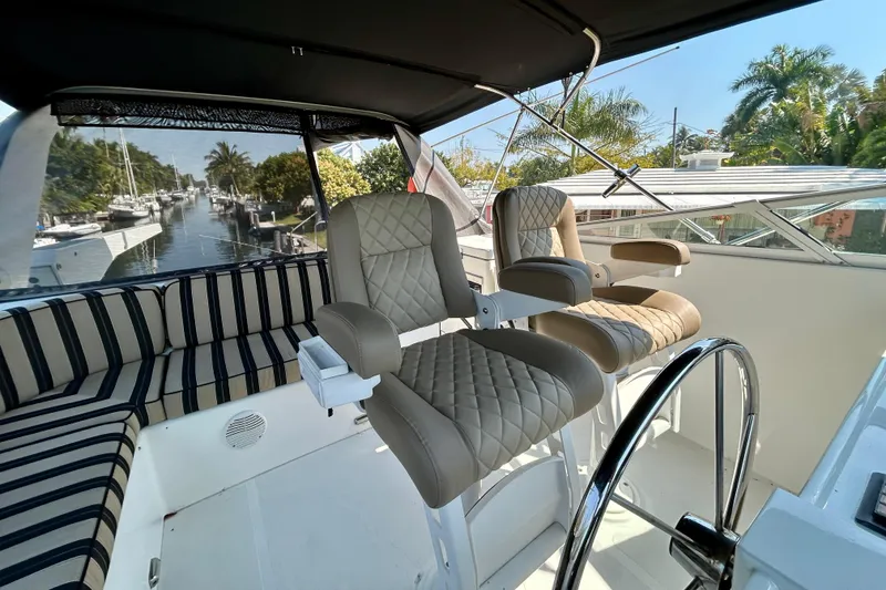 Slide: The Image of Luxurious helm seating on 2000 Pacific Mariner 65 Motoryacht, overlooking serene marina view. - 57