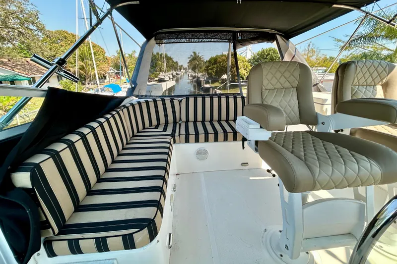 Slide: The Image of Luxurious seating area on 2000 Pacific Mariner 65 Motoryacht with striped cushions and helm chairs. - 59