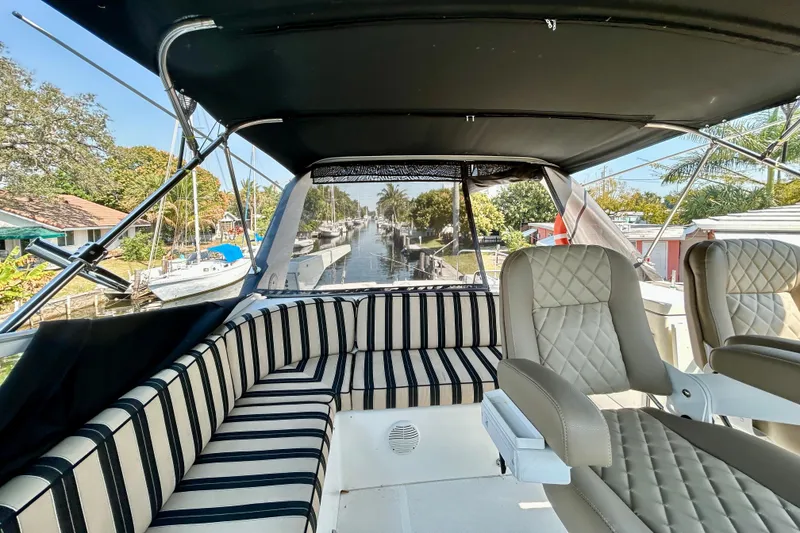 Slide: The Image of 2000 Pacific Mariner 65 Motoryacht interior with striped seating and canal view. - 60