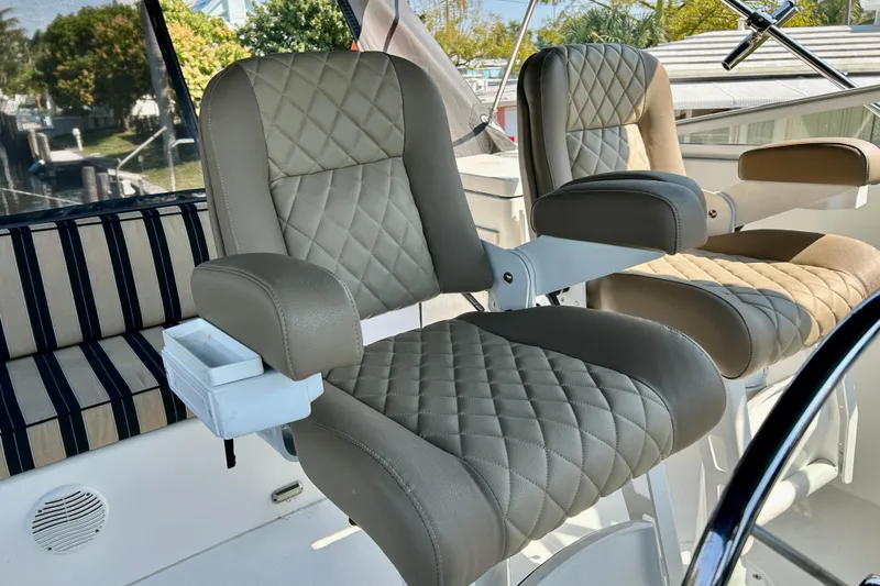 Slide: The Image of Luxurious seating on a 2000 Pacific Mariner 65 Motoryacht, featuring quilted leather chairs. - 63