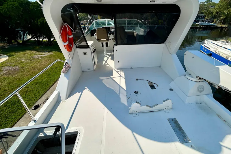 Slide: The Image of 2000 Pacific Mariner 65 Motoryacht deck with seating and safety equipment. - 67