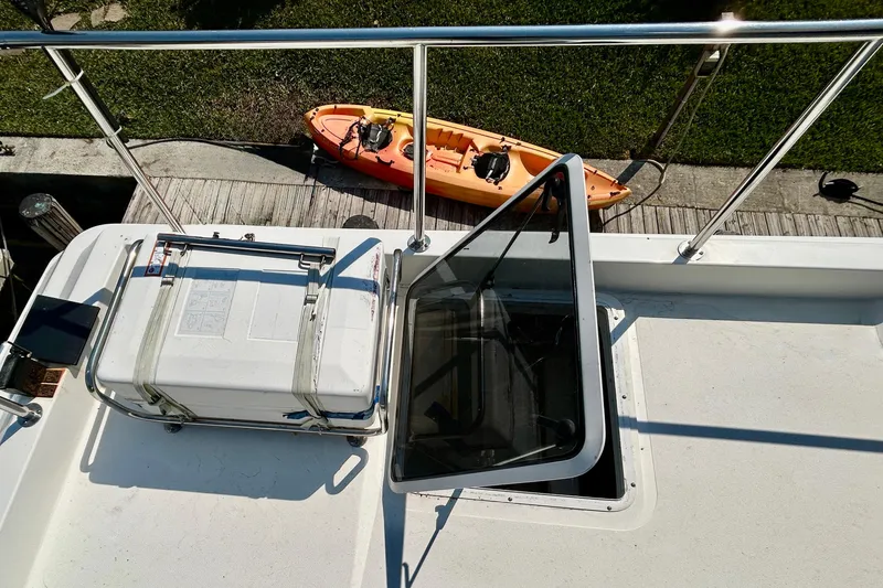 Slide: The Image of Rooftop view of 2000 Pacific Mariner 65 Motoryacht with kayak and hatch. - 69