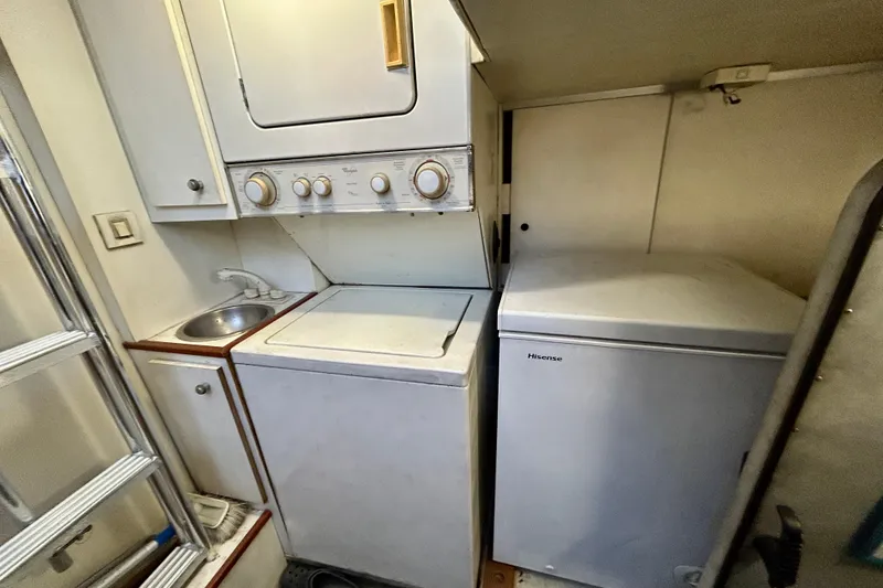 Slide: The Image of Laundry area in 2000 Pacific Mariner 65 Motoryacht with washer, dryer, and Hisense freezer. - 72