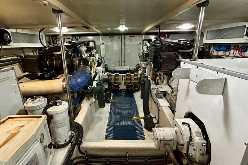 Slide: The Image of Engine room of 2000 Pacific Mariner 65 Motoryacht, showcasing mechanical components and equipment. - 74