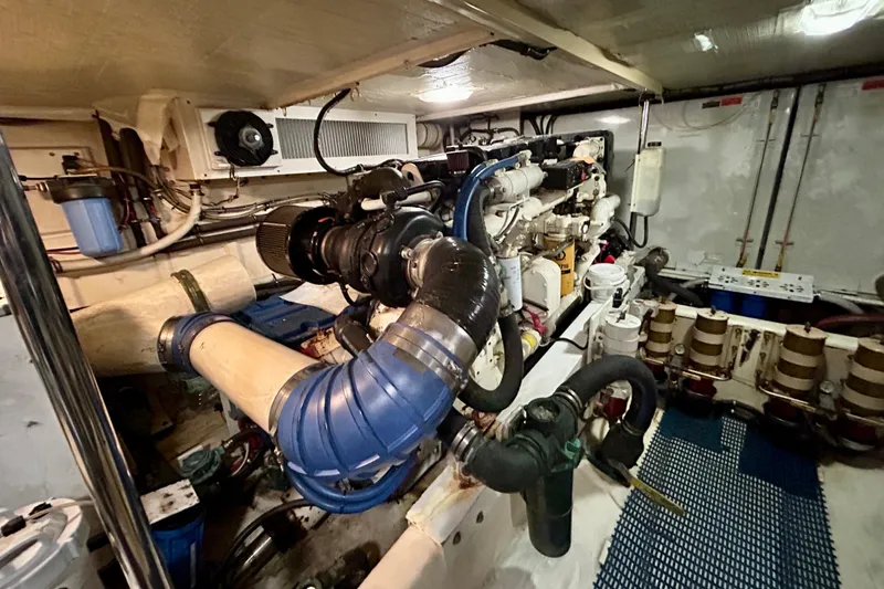 Slide: The Image of Engine room of a 2000 Pacific Mariner 65 Motoryacht, showcasing complex machinery and piping. - 75