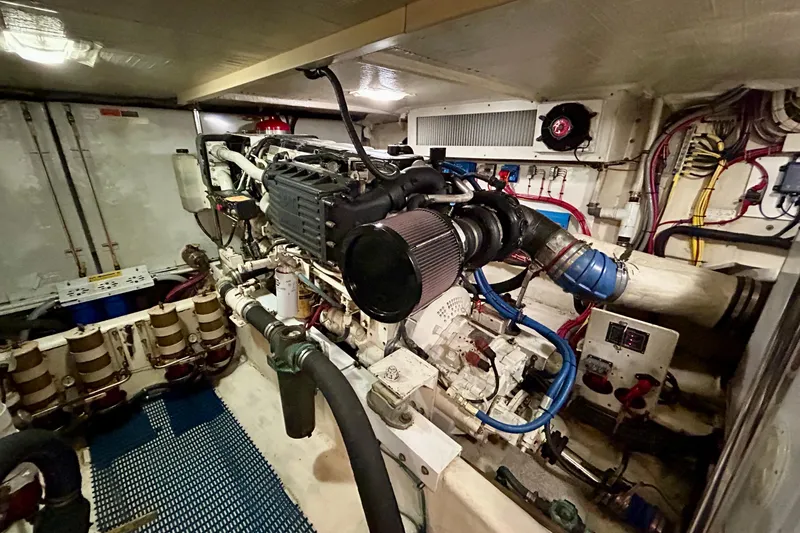 Slide: The Image of Engine room of a 2000 Pacific Mariner 65 Motoryacht, showcasing mechanical components. - 76