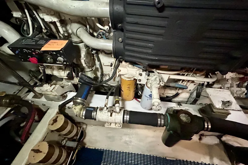 Slide: The Image of Engine room of a 2000 Pacific Mariner 65 Motoryacht, showcasing mechanical components and filters. - 81