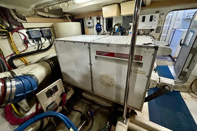 Slide: The Image of Engine room of 2000 Pacific Mariner 65 Motoryacht with generator and wiring. - 82