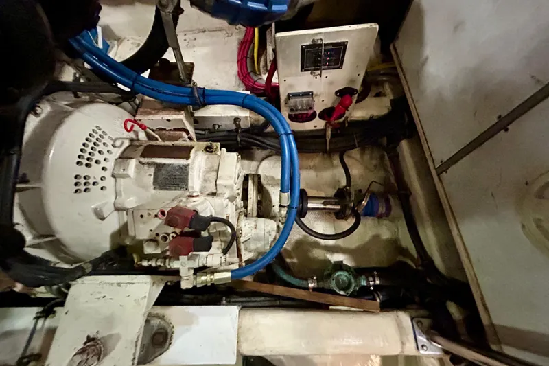 Slide: The Image of Engine room of a 2000 Pacific Mariner 65 Motoryacht with visible machinery and wiring. - 83
