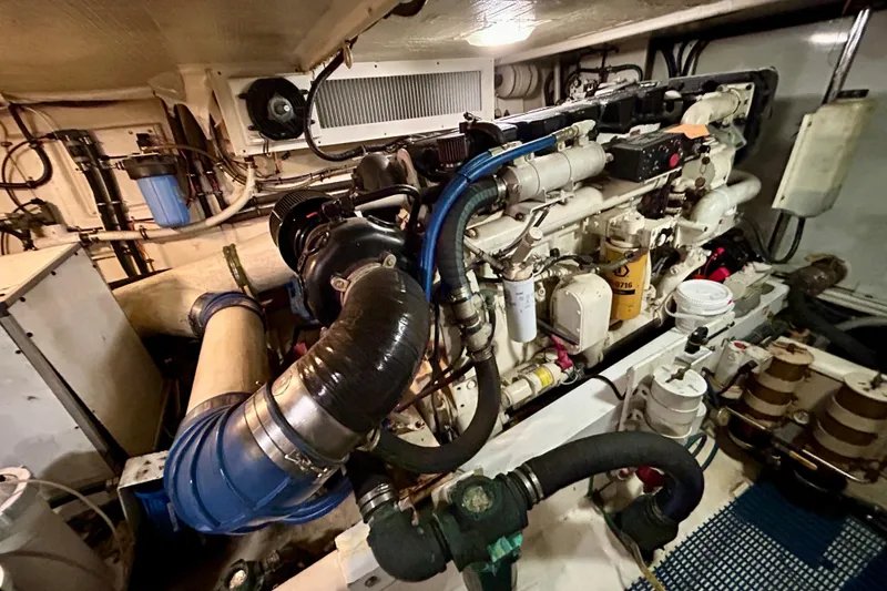 Slide: The Image of Engine room of a 2000 Pacific Mariner 65 Motoryacht, showcasing mechanical components and piping. - 88