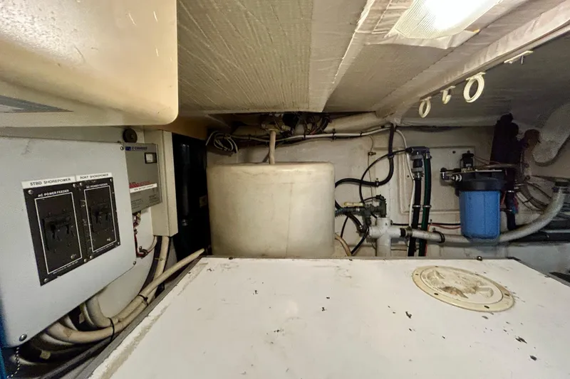Slide: The Image of Engine room of 2000 Pacific Mariner 65 Motoryacht with electrical panels and plumbing. - 96