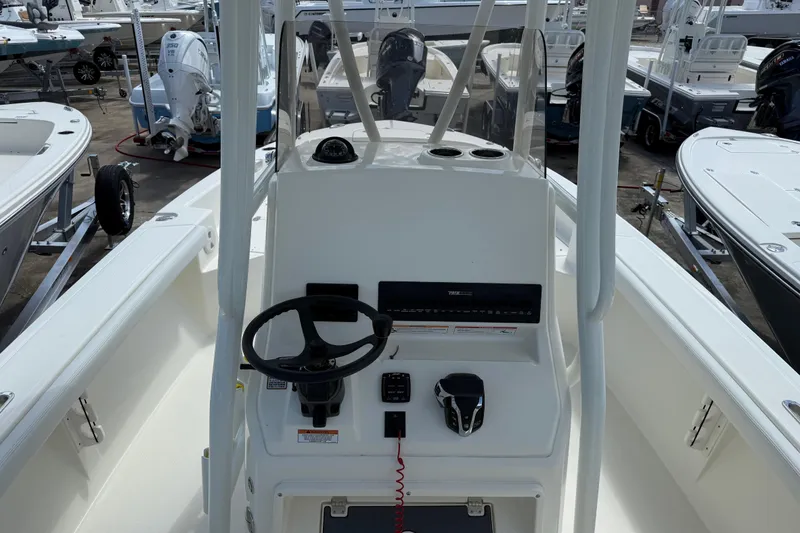 Slide: The Image of 2026 Pathfinder F350XSA2 boat console with steering wheel and controls in a marina. - 7