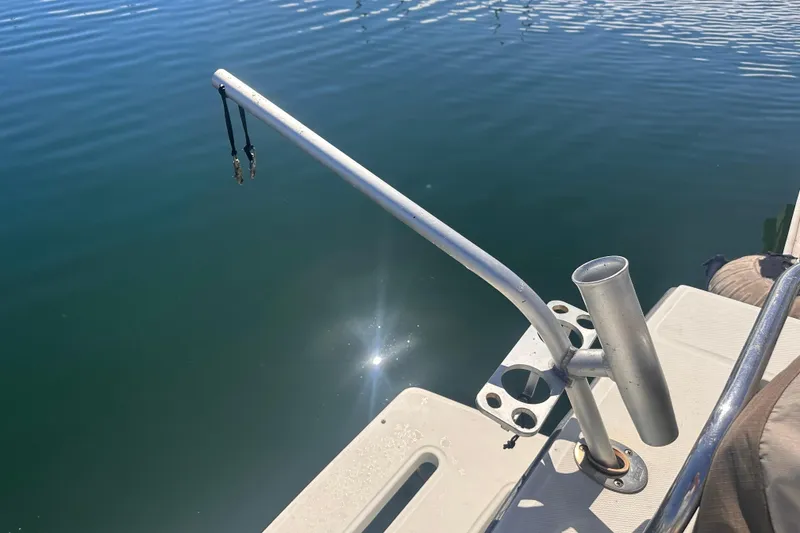 Slide: The Image of 2004 Carolina Classic Express Cabin Cruiser with fishing rod holder on deck. - 11