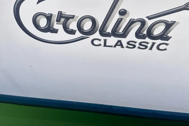 Slide: The Image of 2004 Carolina Classic Express Cabin Cruiser logo on boat exterior. - 15