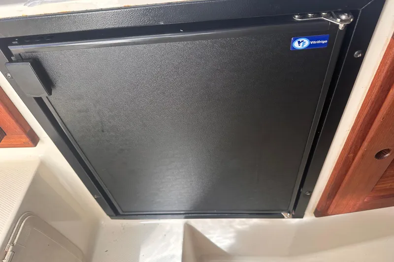 Slide: The Image of 2004 Carolina Classic Express Cabin Cruiser interior with a Vitrifrigo refrigerator. - 18