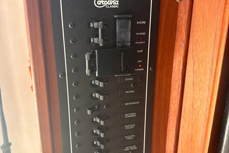 Slide: The Image of Control panel of a 2004 Carolina Classic Express Cabin Cruiser with switches and labels. - 23