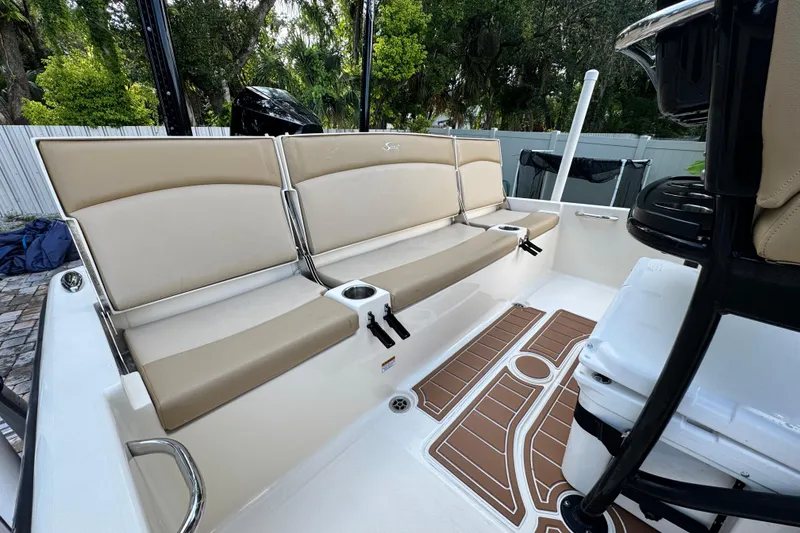 Slide: The Image of 2020 Scout 251 XSS boat with beige seating on calm water. - 10