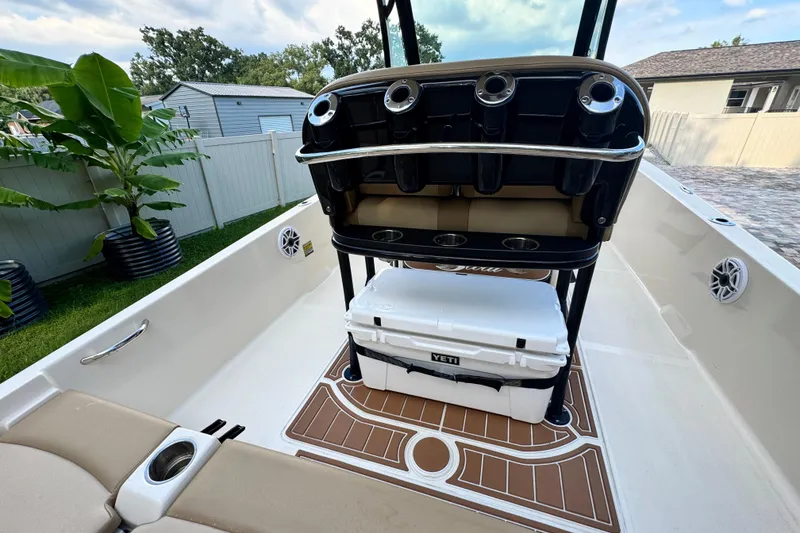 Slide: The Image of 2020 Scout 251 XSS boat on calm water near waterfront buildings. - 13