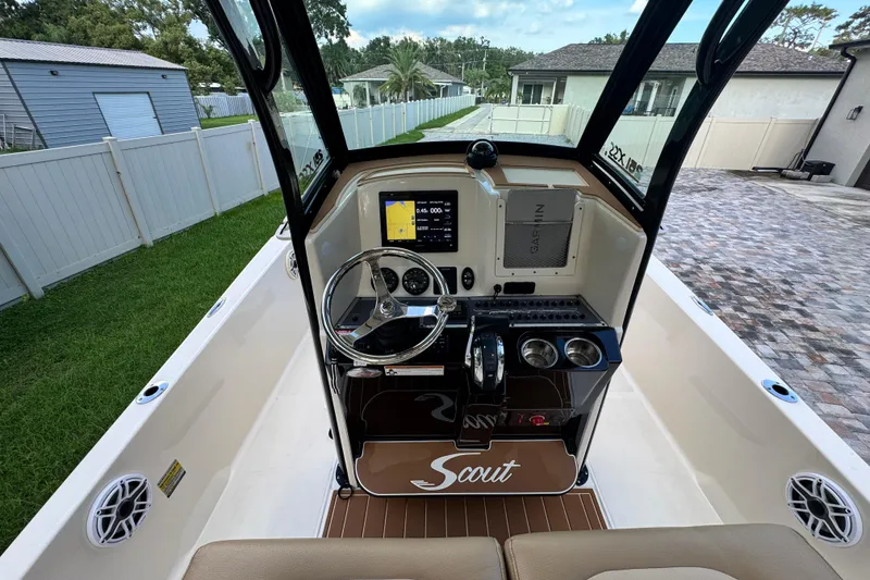 Slide: The Image of 2020 Scout 251 XSS boat on a Rocket trailer, parked on a paved driveway. - 15