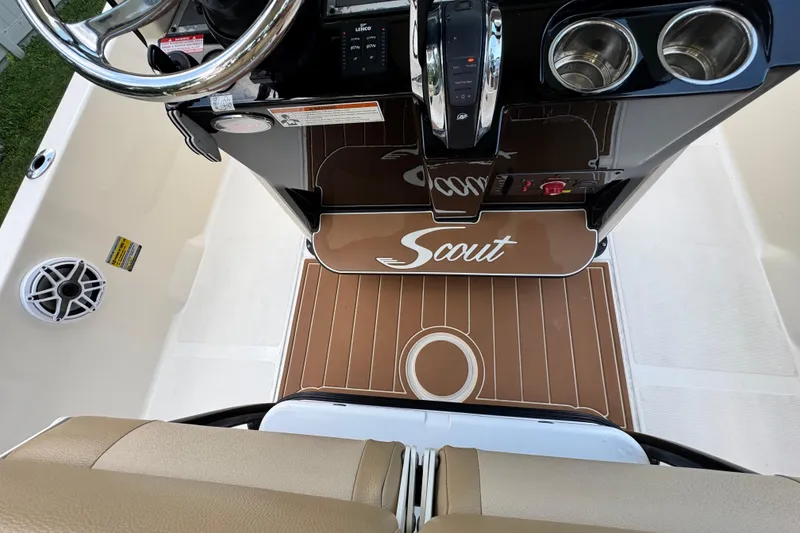 Slide: The Image of 2020 Scout 251 XSS boat interior with tan seating and Mercury engine. - 18