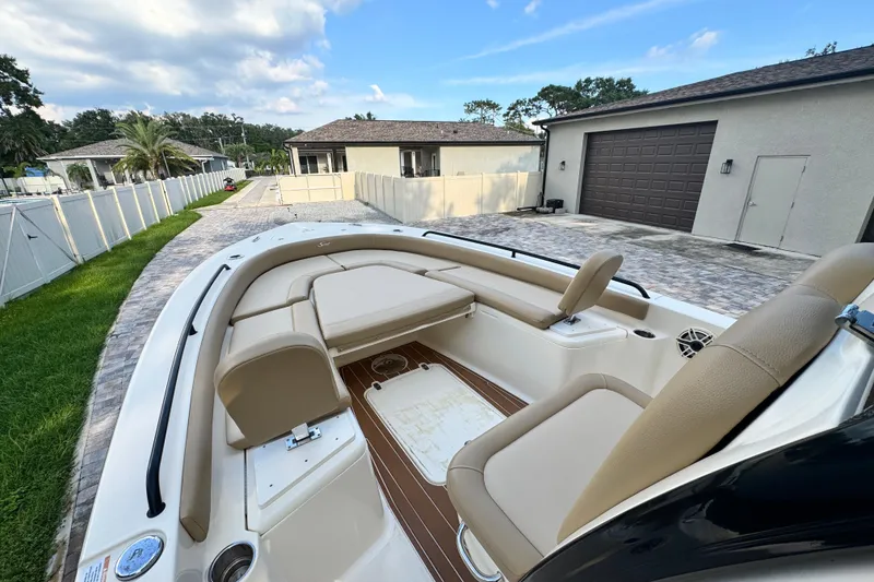 Slide: The Image of 2020 Scout 251 XSS boat interior with beige seating and teak-style flooring. - 19