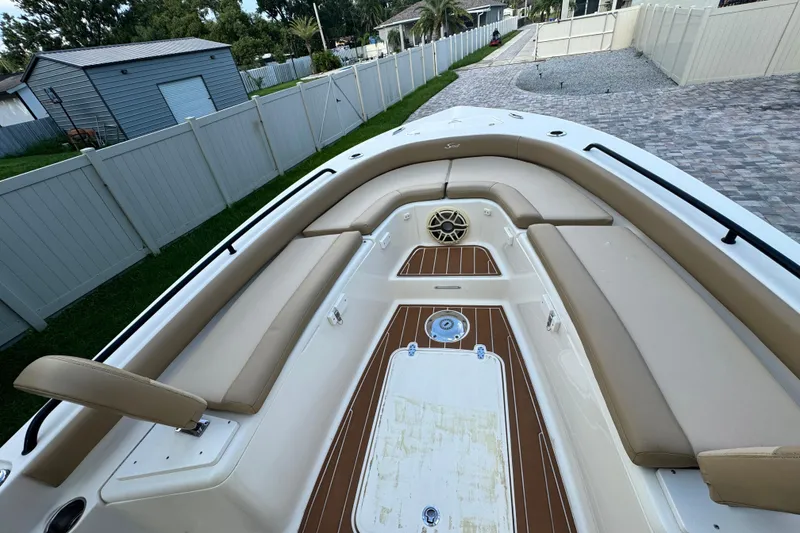 Slide: The Image of 2020 Scout 251 XSS boat interior with seating, storage compartments, and outboard motor. - 21