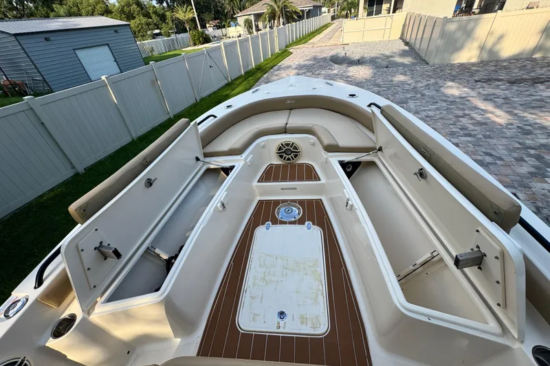 Slide: The Image of 2020 Scout 251 XSS boat interior with seating, rod holders, and Yeti cooler. - 22