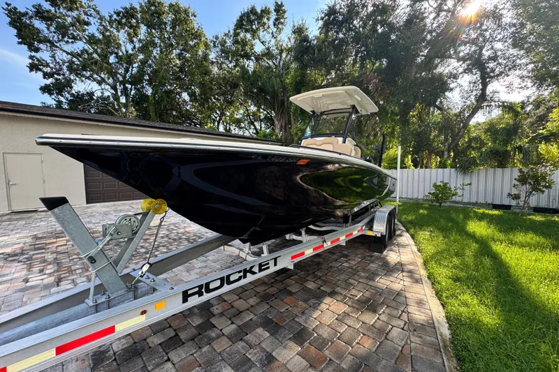 Slide: The Image of 2020 Scout 251 XSS boat on calm water with cityscape background. - 4