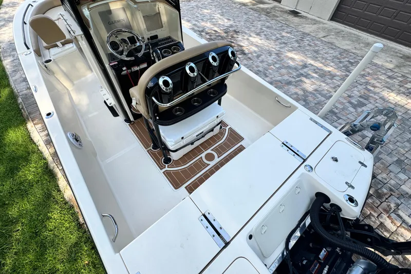 Slide: The Image of 2020 Scout 251 XSS boat with Mercury engine, featuring spacious seating and sleek design on water. - 8