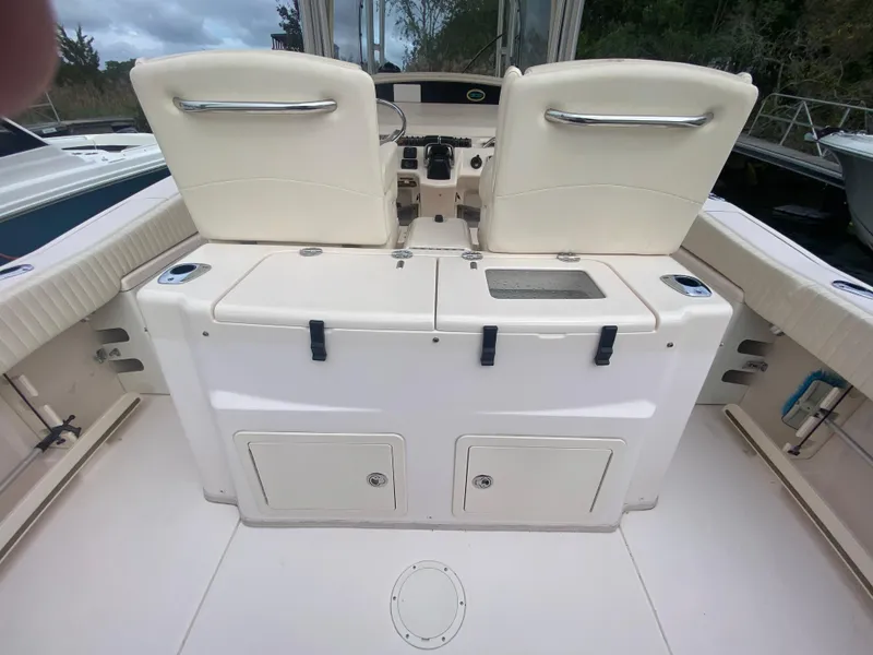 Slide: The Image of 2014 Grady-White Canyon 306 boat interior with dual seats and storage compartments. - 11