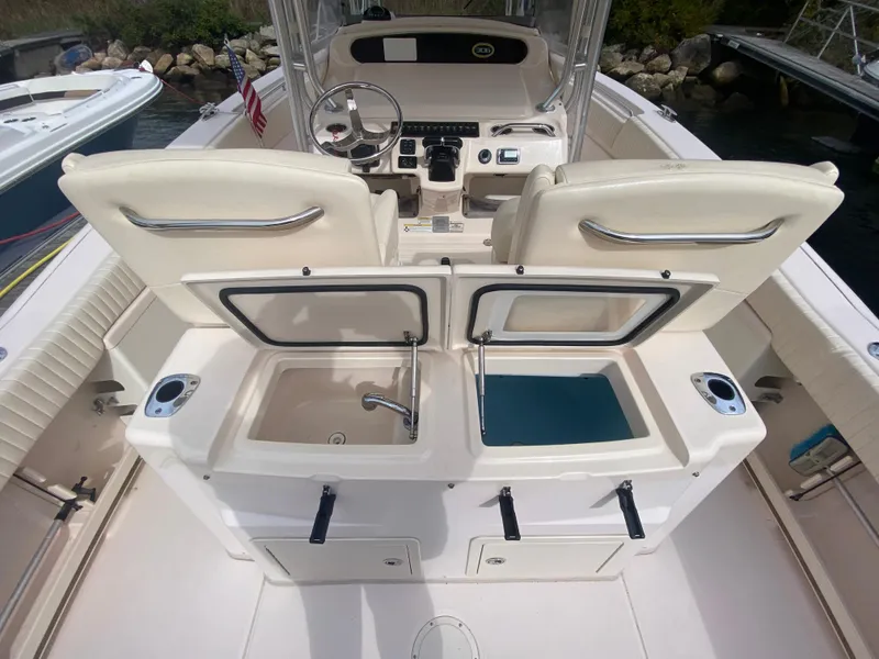Slide: The Image of 2014 Grady-White Canyon 306 boat interior with dual sinks and storage compartments. - 12