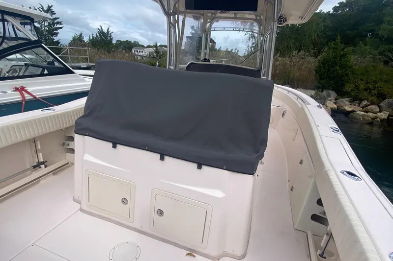 Slide: The Image of 2014 Grady-White Canyon 306 boat interior with covered console and storage compartments. - 14