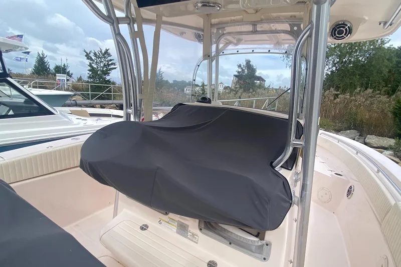 Slide: The Image of 2014 Grady-White Canyon 306 boat with covered console, docked outdoors. - 15