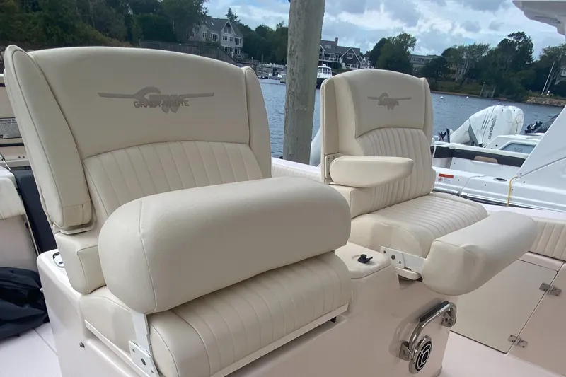 Slide: The Image of 2014 Grady-White Canyon 306 boat seats, cream leather, waterfront view. - 20